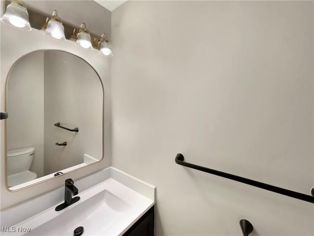 bathroom featuring toilet and vanity