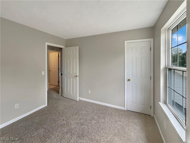 unfurnished bedroom featuring carpet floors