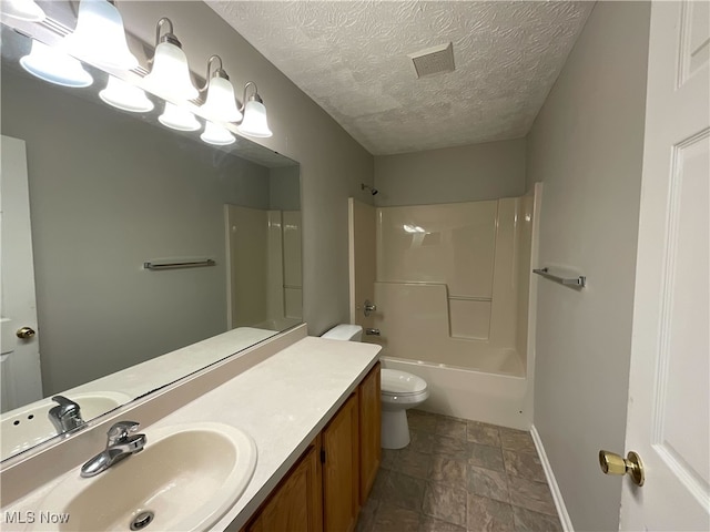 full bathroom with tub / shower combination, a textured ceiling, toilet, and vanity