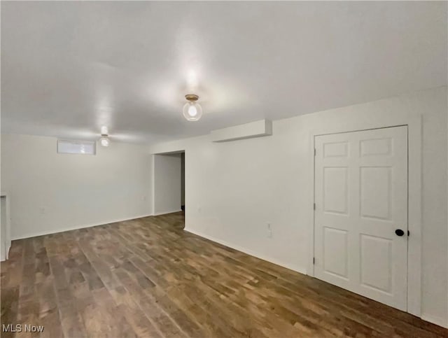 basement with dark hardwood / wood-style floors