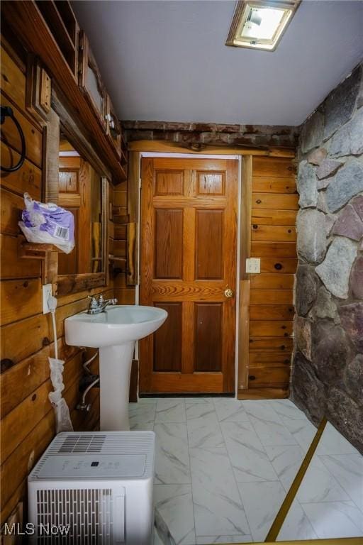 bathroom with wood walls