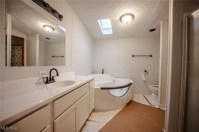 full bathroom with a textured ceiling, vanity, a skylight, toilet, and independent shower and bath