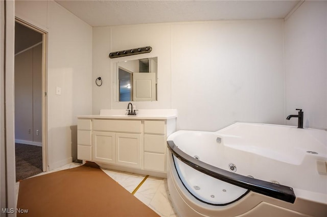 bathroom featuring vanity, a tub, and a textured ceiling