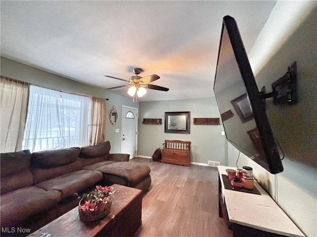 living room featuring ceiling fan and wood-type flooring