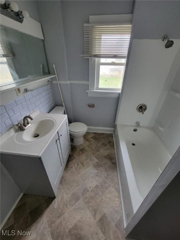 full bathroom featuring tasteful backsplash, vanity, shower / bathing tub combination, and toilet