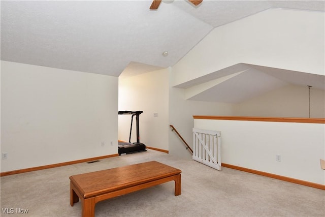 unfurnished room with ceiling fan, vaulted ceiling, and carpet flooring