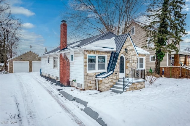 view of front of home featuring a garage and an outdoor structure