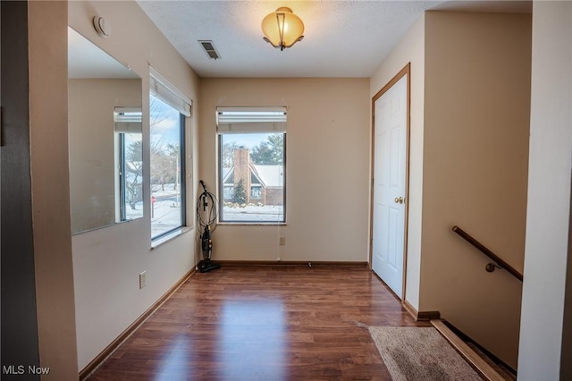 unfurnished room with wood-type flooring