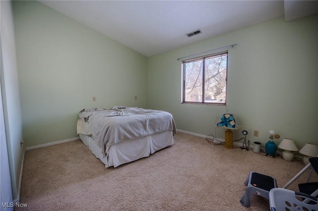 bedroom featuring light carpet and lofted ceiling