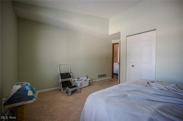 bedroom with light carpet, a closet, and vaulted ceiling