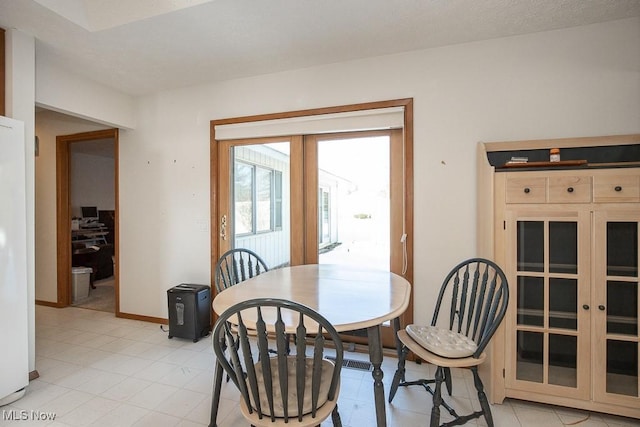 dining space featuring french doors