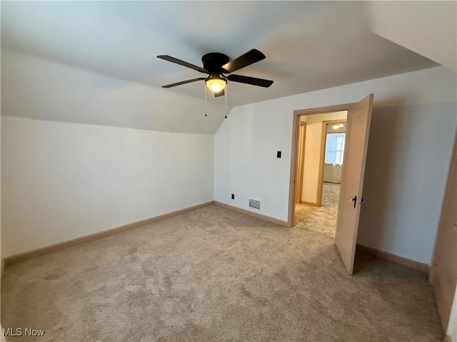 bonus room featuring ceiling fan, light colored carpet, and vaulted ceiling