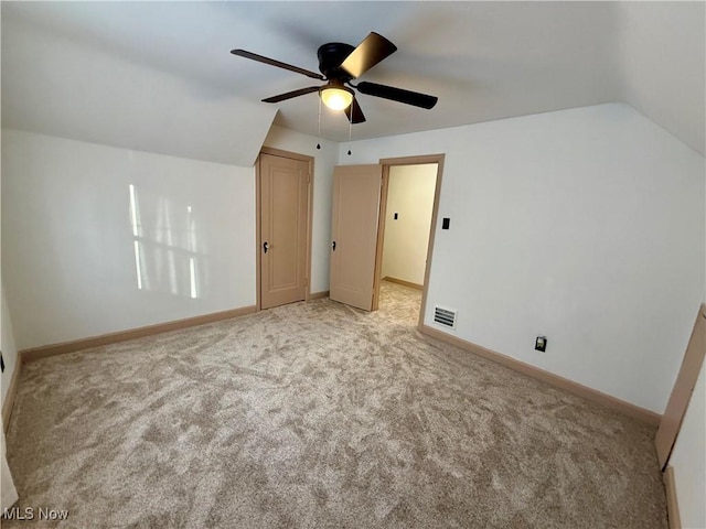 additional living space featuring light carpet, ceiling fan, and lofted ceiling