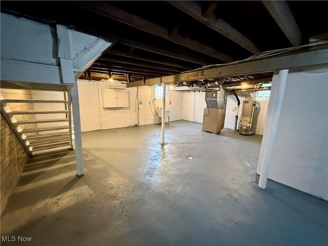 basement featuring heating unit and gas water heater