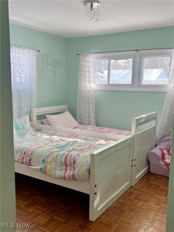 bedroom with light parquet floors