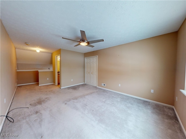 carpeted spare room with a textured ceiling