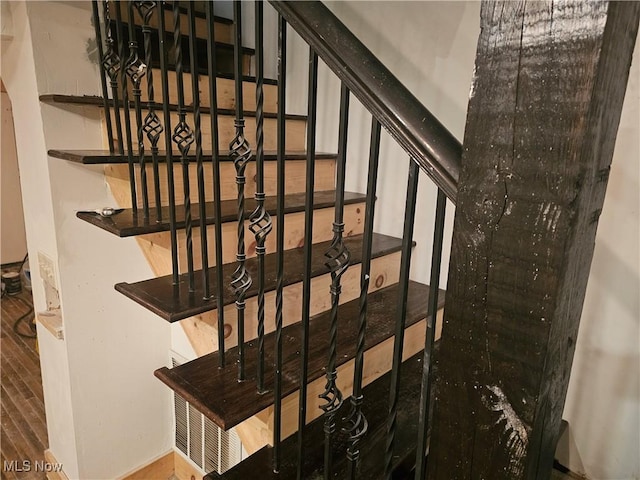 staircase with hardwood / wood-style floors