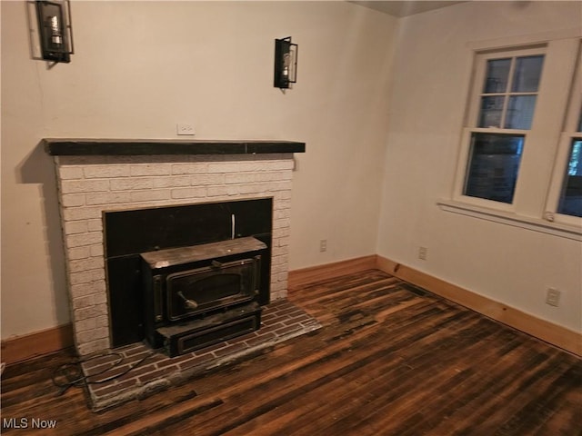 unfurnished living room featuring a wood stove and dark hardwood / wood-style floors