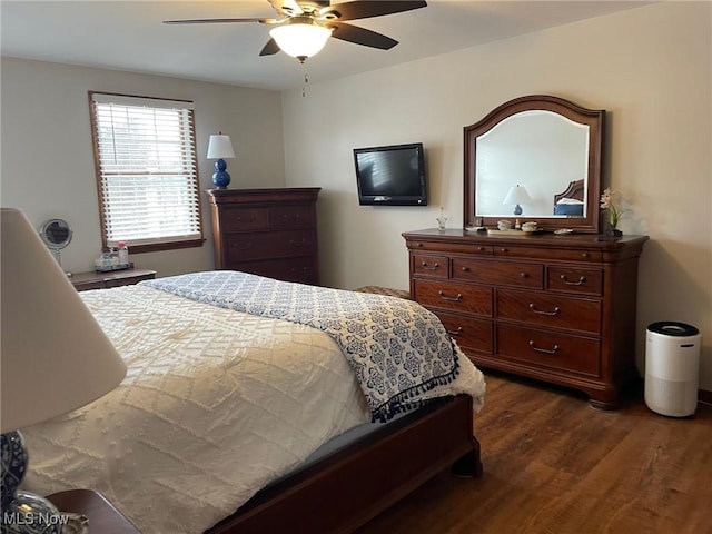 bedroom featuring ceiling fan and dark hardwood / wood-style floors