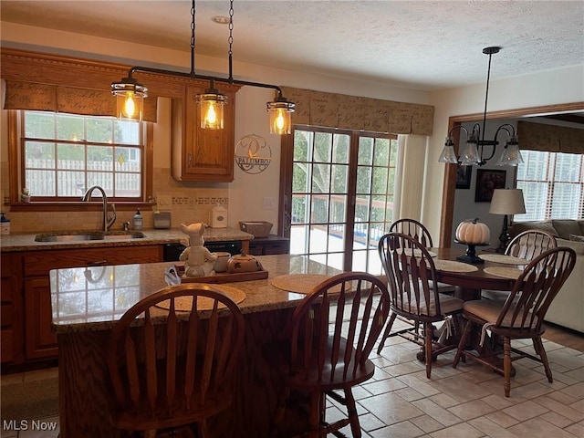 dining area with a textured ceiling and sink