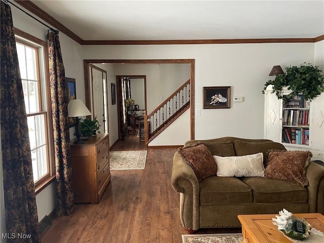 living room with dark hardwood / wood-style floors and crown molding