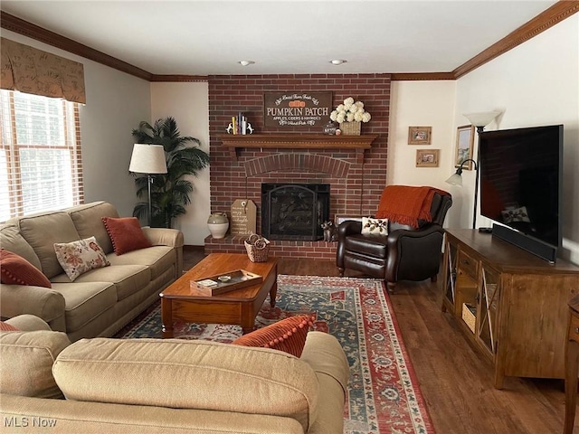 living room featuring dark hardwood / wood-style floors, crown molding, and a brick fireplace