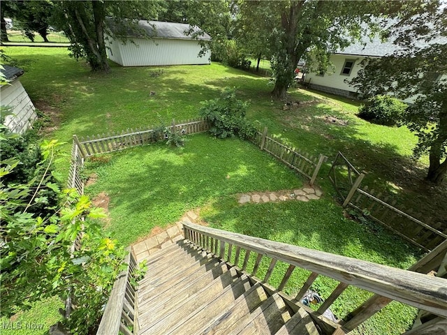 view of yard with a wooden deck and a storage unit