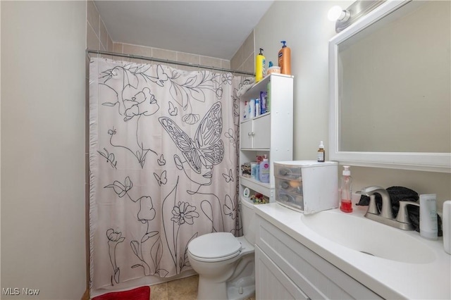 bathroom with toilet, tile patterned floors, and vanity