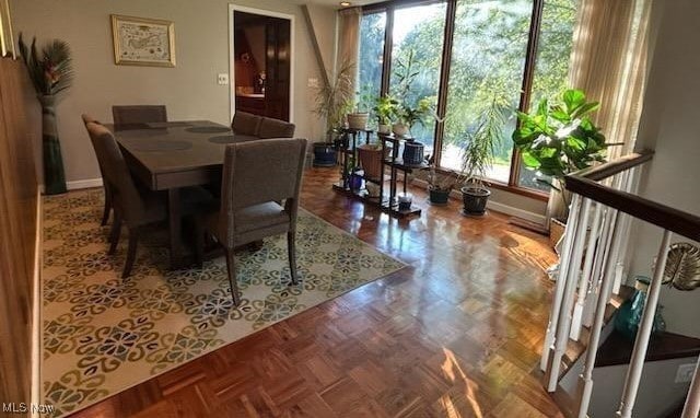 dining space with a wealth of natural light and parquet floors