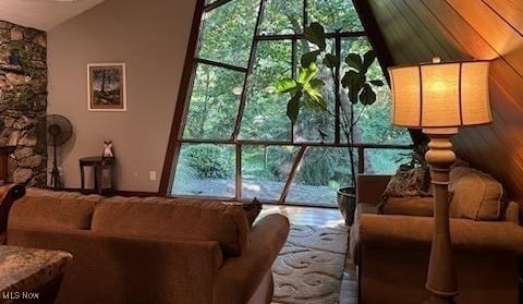 living room featuring vaulted ceiling and a fireplace