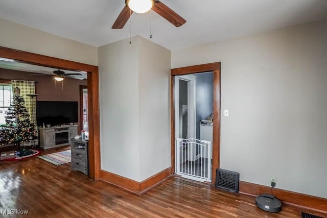 unfurnished room featuring ceiling fan and dark hardwood / wood-style flooring