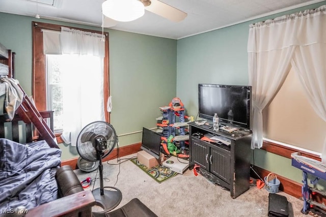 interior space with ceiling fan and carpet