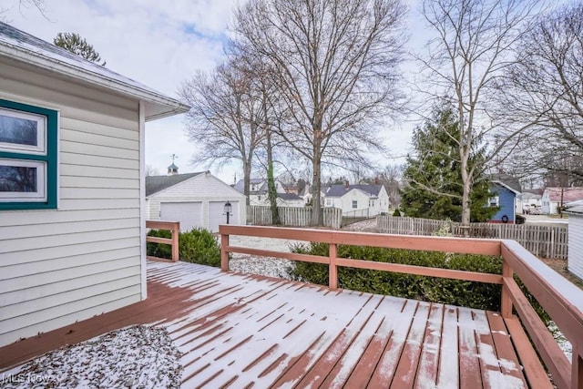 wooden deck with an outdoor structure and a garage