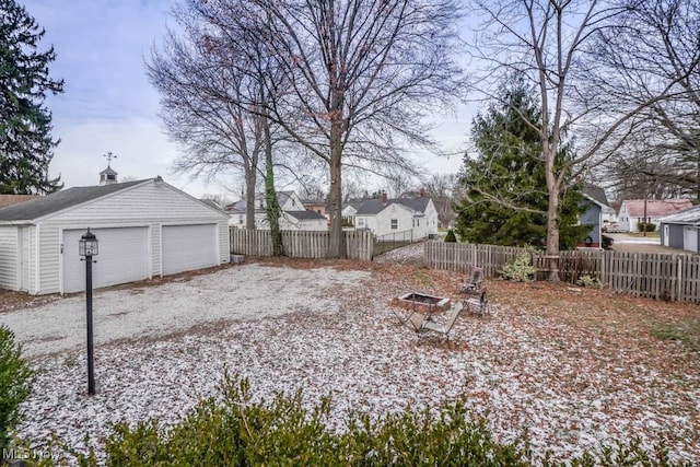 view of yard with a garage and an outbuilding