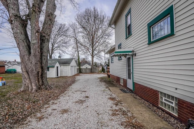 view of home's exterior with a storage shed