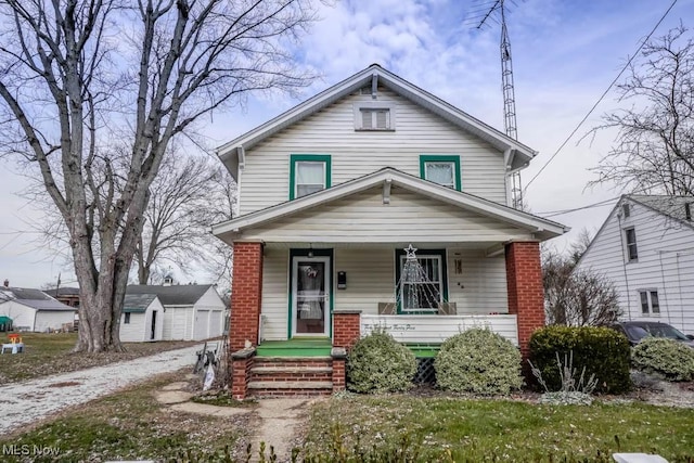 bungalow with an outbuilding, covered porch, and a garage