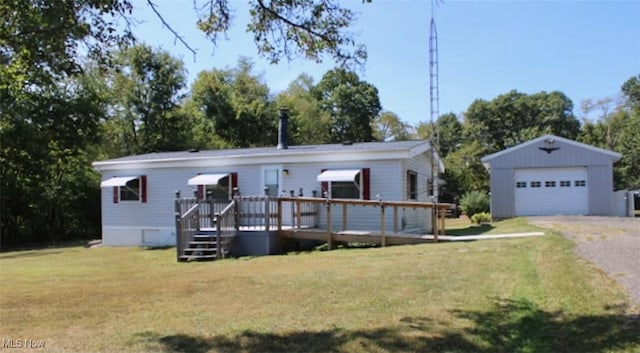 view of front facade featuring a front yard, an outdoor structure, a wooden deck, and a garage