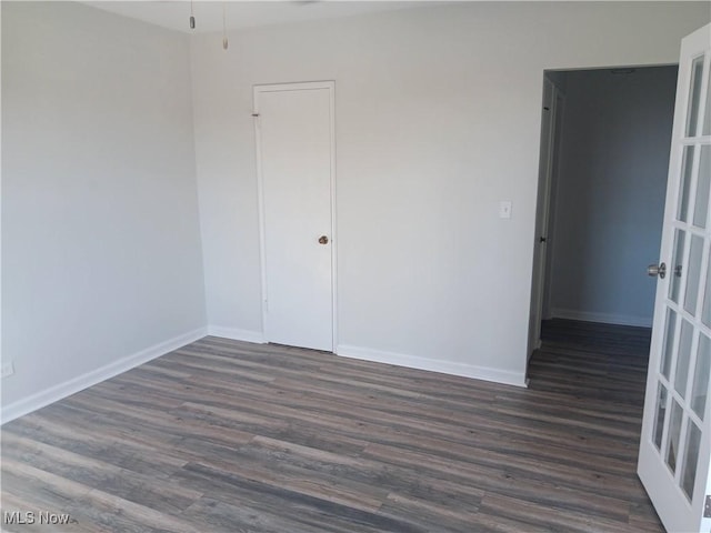 empty room featuring dark hardwood / wood-style flooring