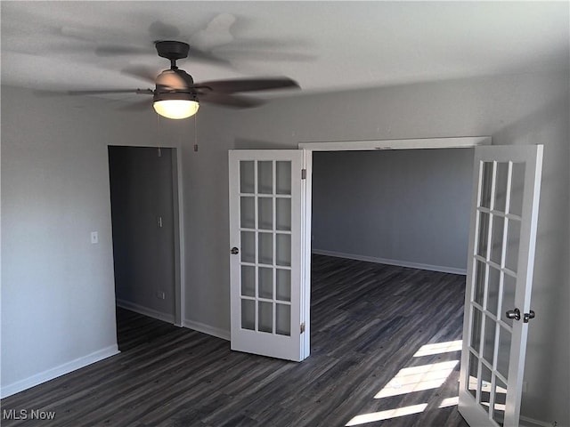 spare room with ceiling fan, dark hardwood / wood-style flooring, and french doors