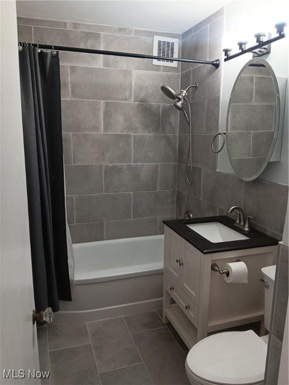 full bathroom featuring toilet, tile patterned flooring, shower / bathtub combination with curtain, and vanity