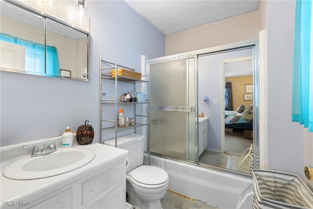 full bathroom featuring toilet, enclosed tub / shower combo, and vanity