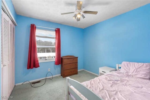 bedroom with light carpet, a closet, and ceiling fan