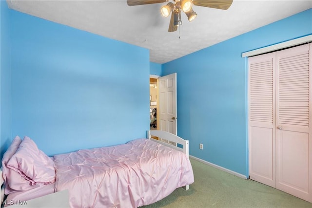 unfurnished bedroom featuring ceiling fan, light colored carpet, and a closet