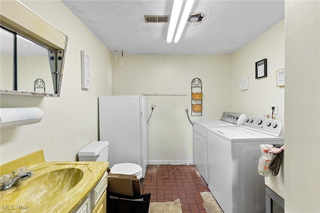 laundry room featuring separate washer and dryer and sink