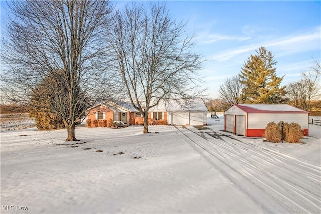 yard covered in snow featuring a garage