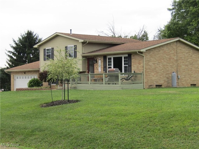 tri-level home featuring a garage and a front yard