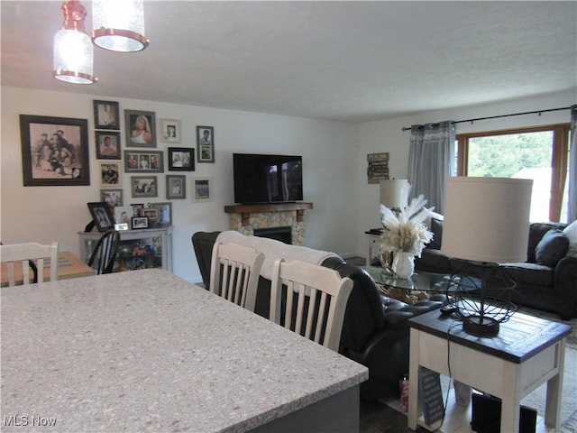 dining space with a stone fireplace