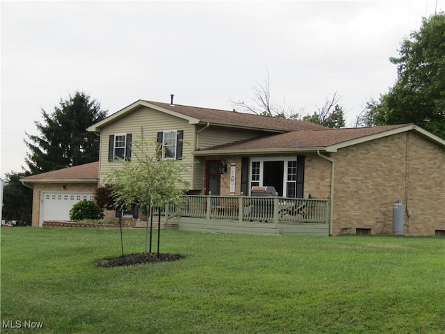 tri-level home featuring a front yard and a garage