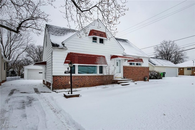 view of front of property with a garage and an outbuilding