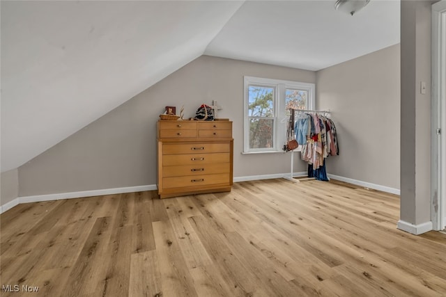 bonus room with light hardwood / wood-style flooring and vaulted ceiling